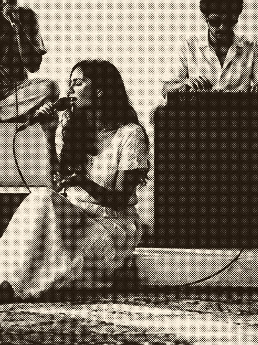 A singer mid-take, up close